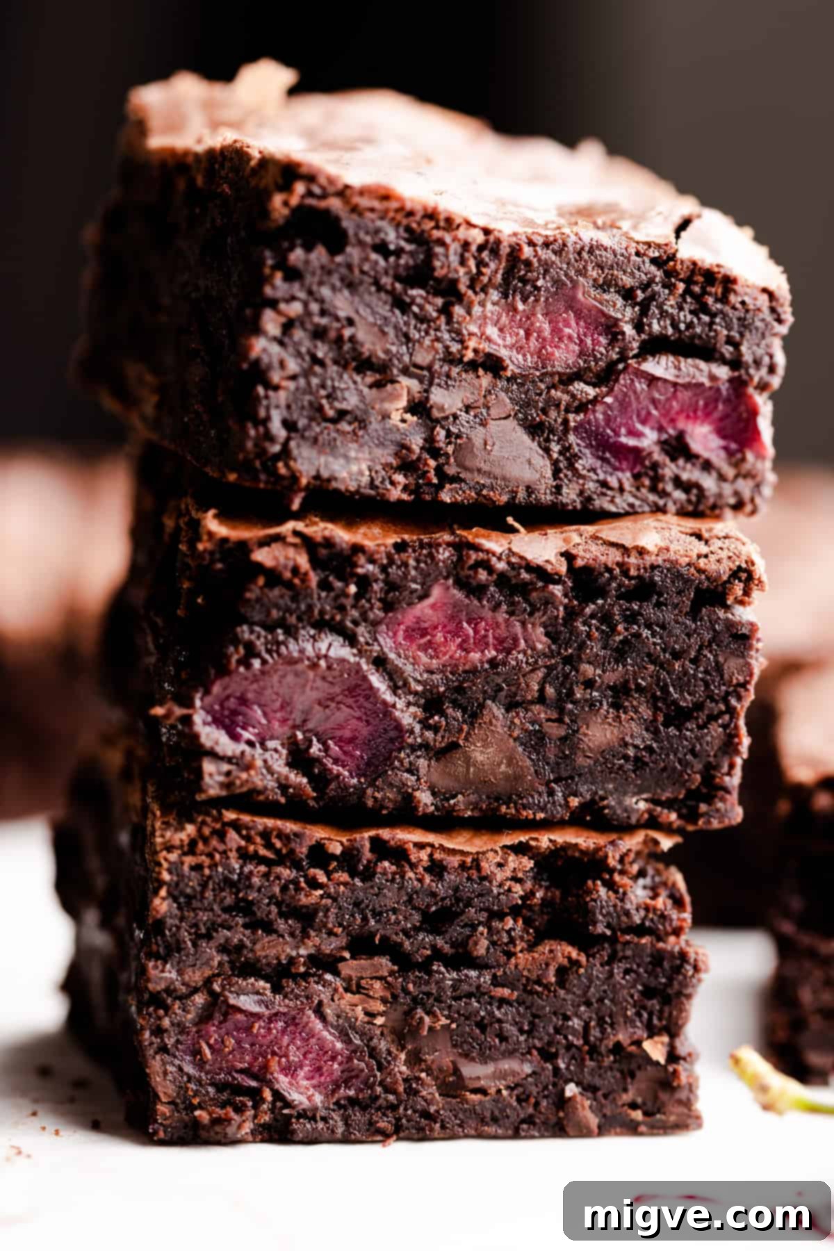 side super close up at a stack of three chocolate cherry brownies