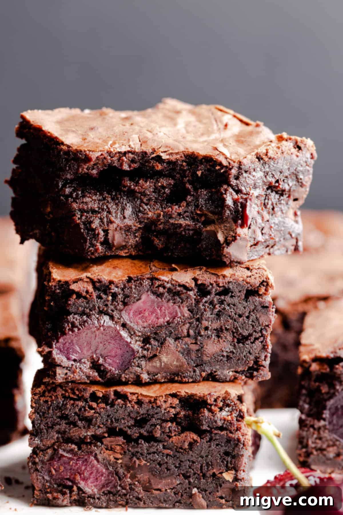 straight ahead view of stack of brownies with bite missing from the top one