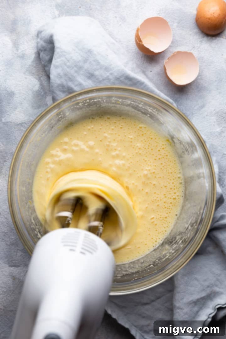 top view of eggs and sugar being whisked