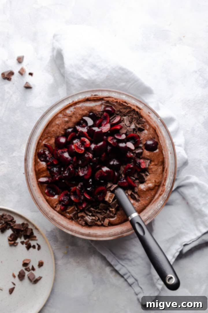 top view of bowl with brownie batter and cherries on top
