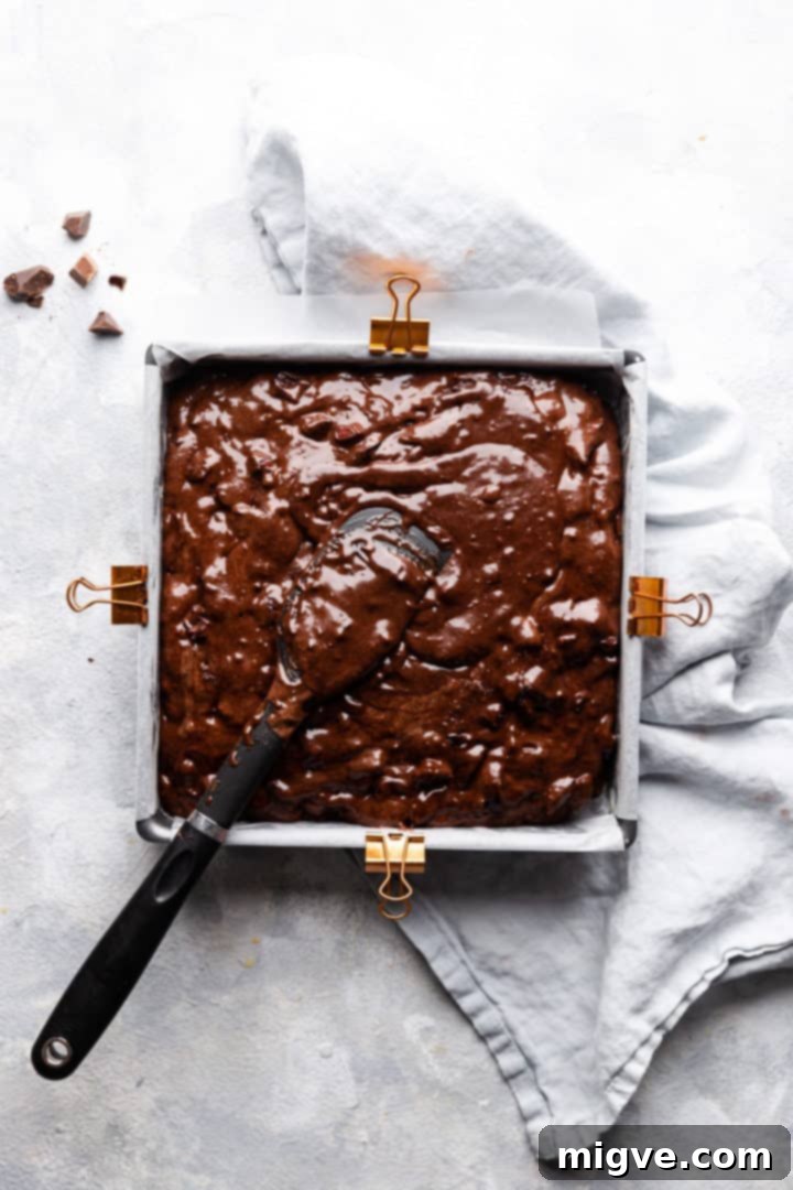 overhead shot of square baking tin with brownie batter