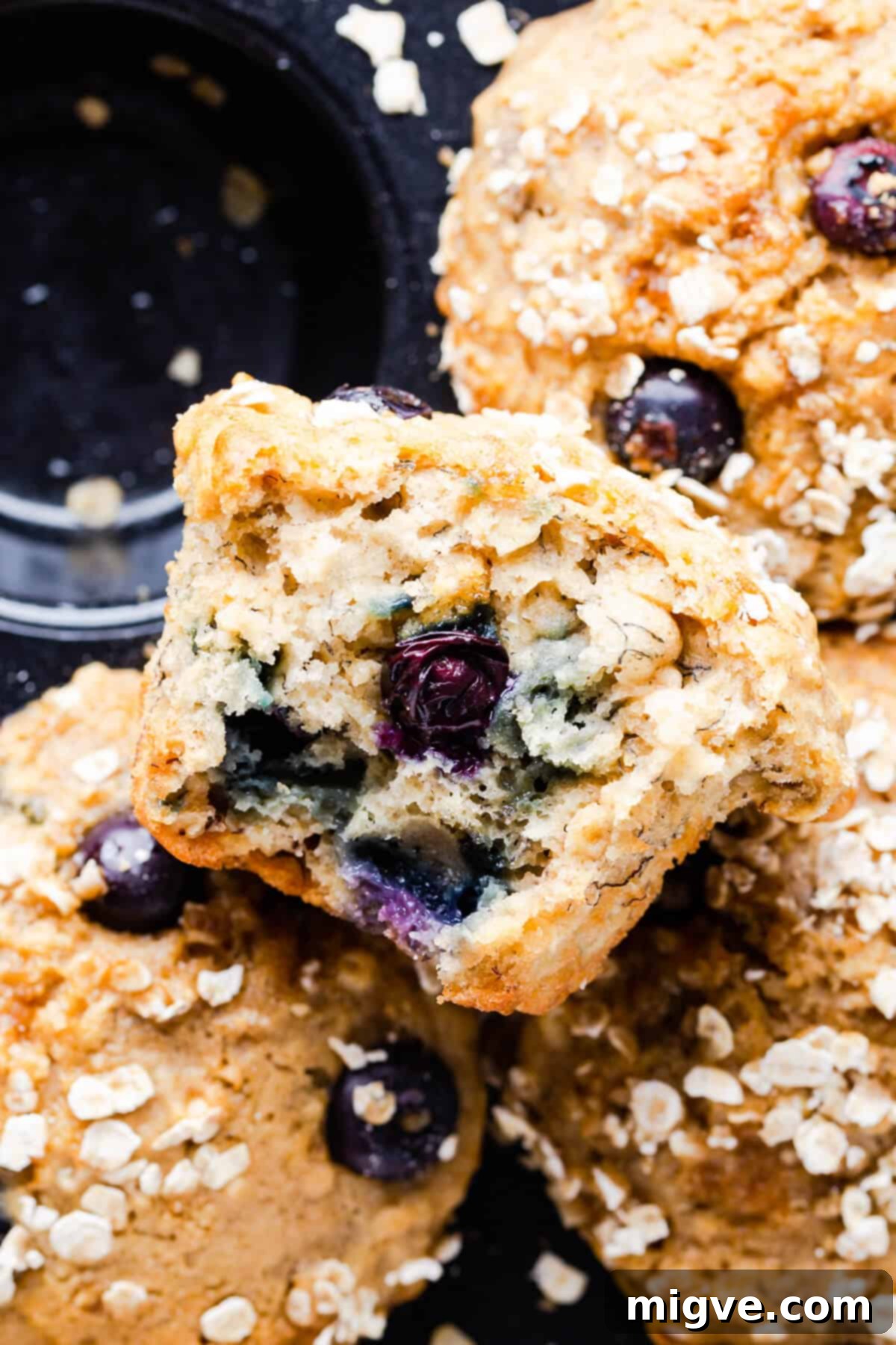 Close-up overhead shot of a single banana and blueberry muffin, its golden top speckled with juicy blueberries, ready to be enjoyed.