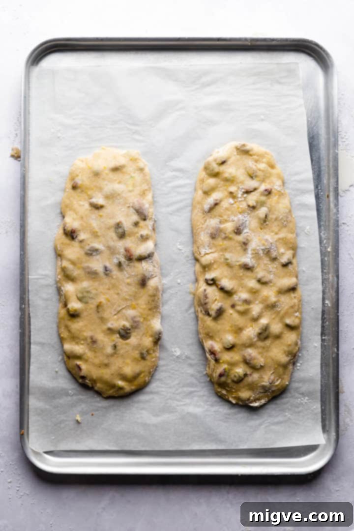 two logs of biscotti dough on a baking tray
