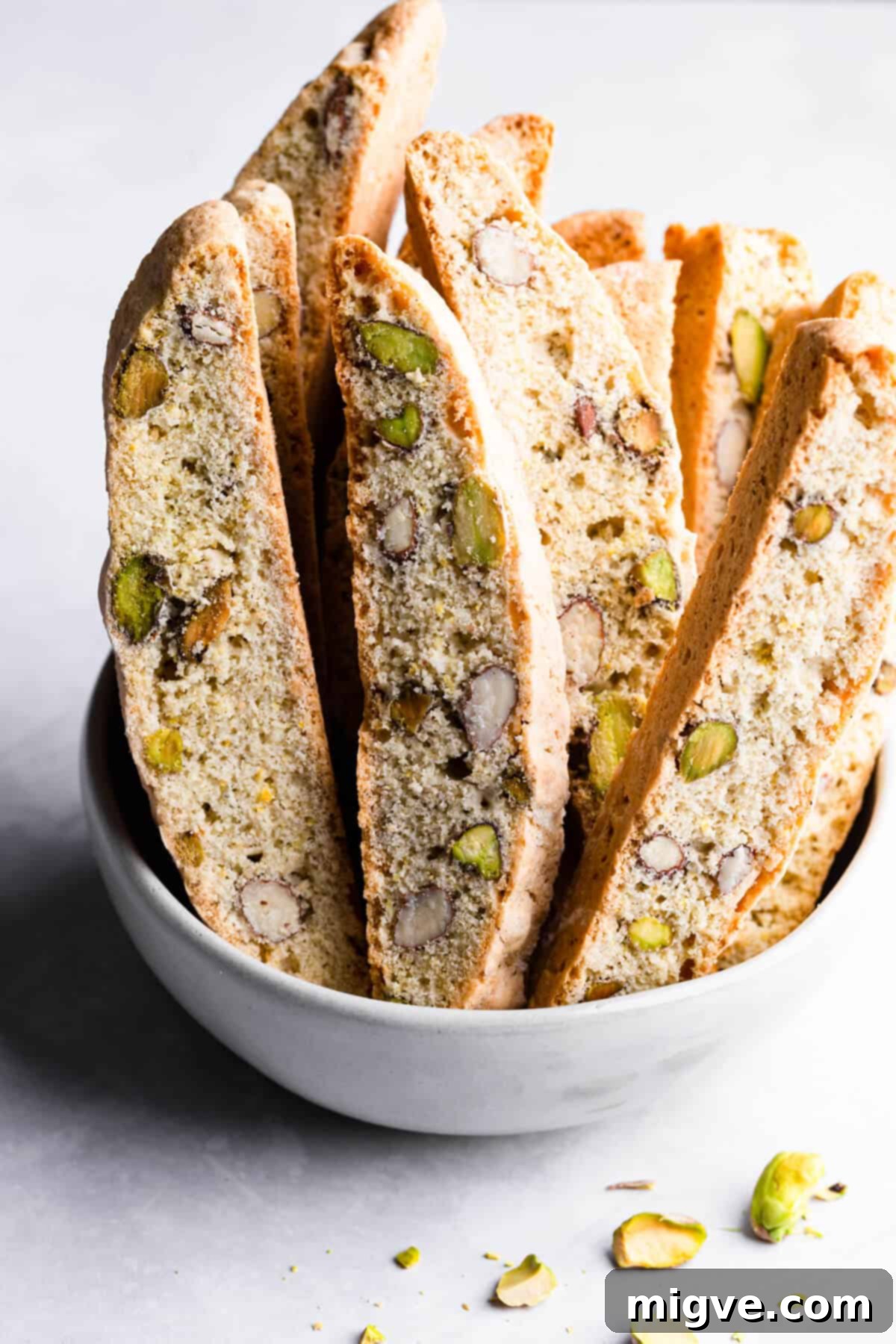 side close up at lemon pistachio biscotti in a bowl