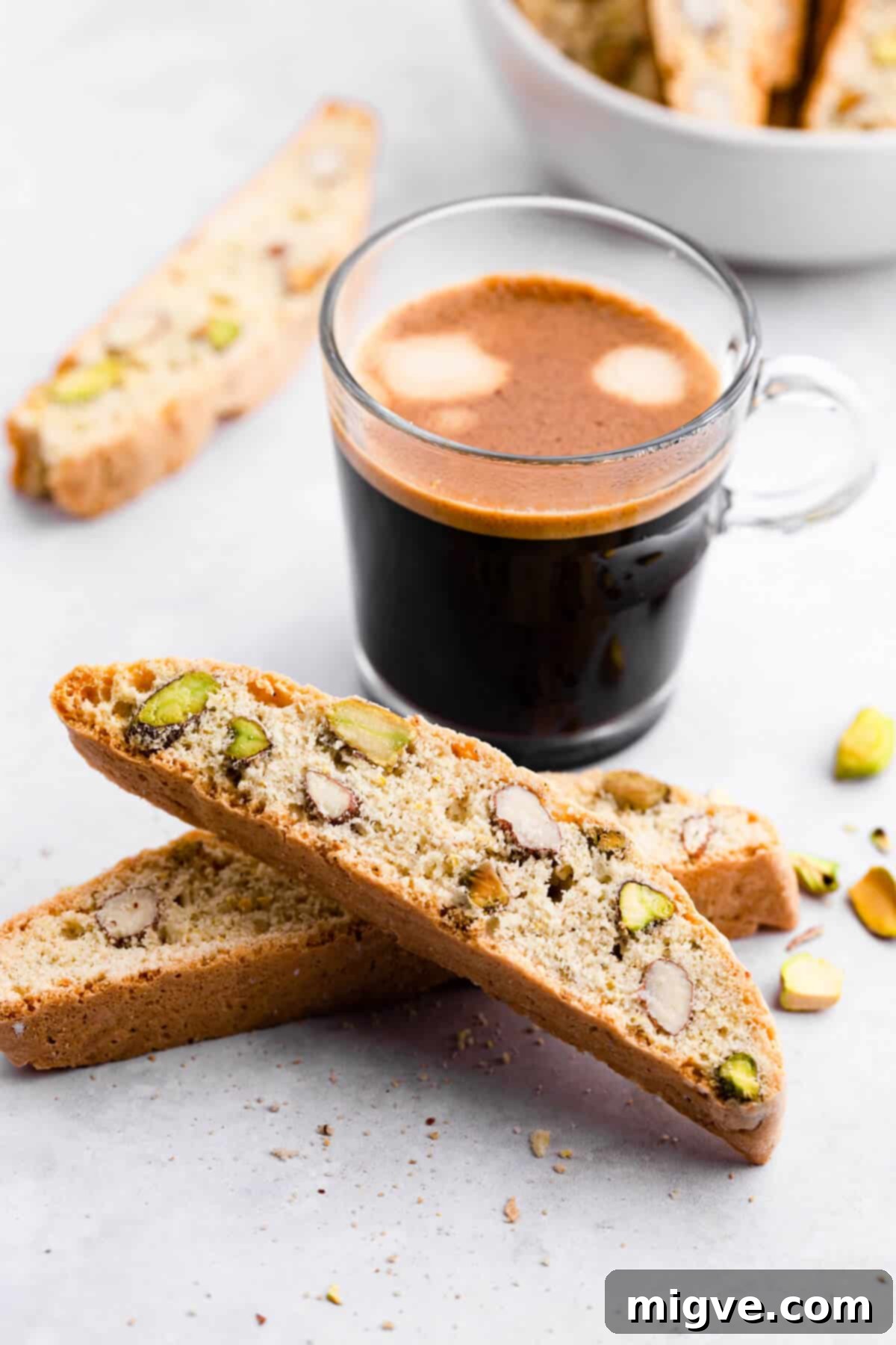 45 degree angle view of couple of slices of lemon pistachio biscotti