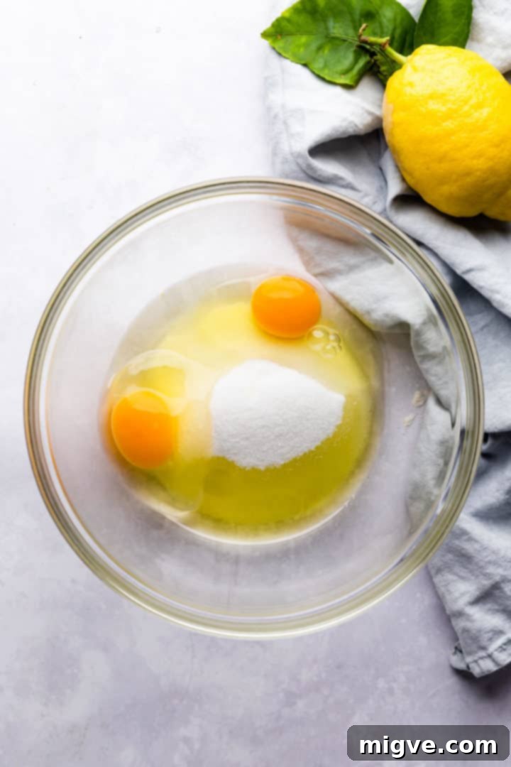 top view of a bowl with eggs and sugar