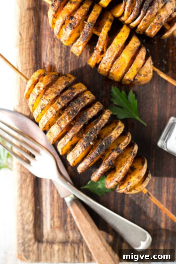 Golden Spiral Roasted Potatoes 3 Freshly baked Tornado Potatoes on skewers, seasoned perfectly for a delightful vegan snack or side dish.