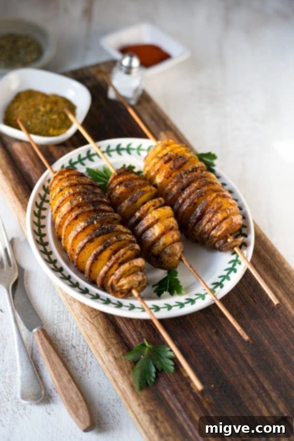 Golden Spiral Roasted Potatoes 7 The process of preparing Tornado Potatoes, showing the careful handling of potatoes and skewers.