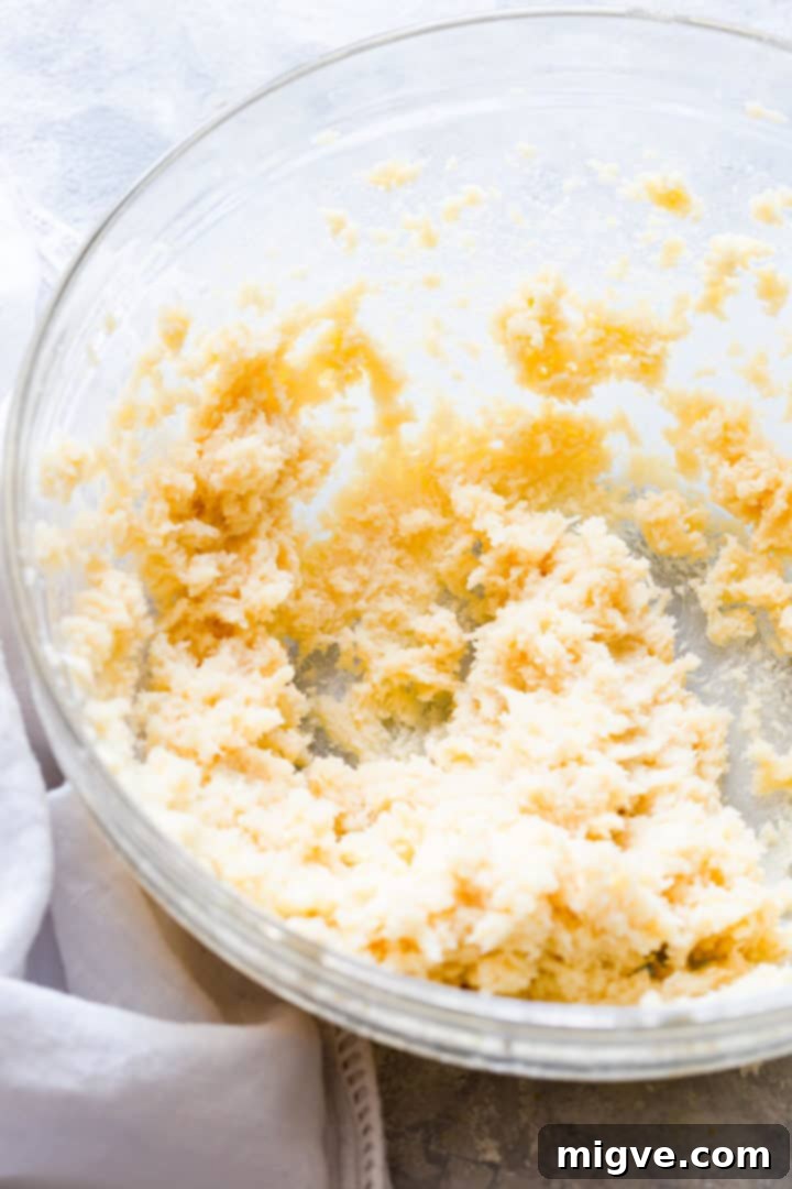 Close-up of perfectly whipped butter and sugar in a bowl, demonstrating the desired fluffy consistency.