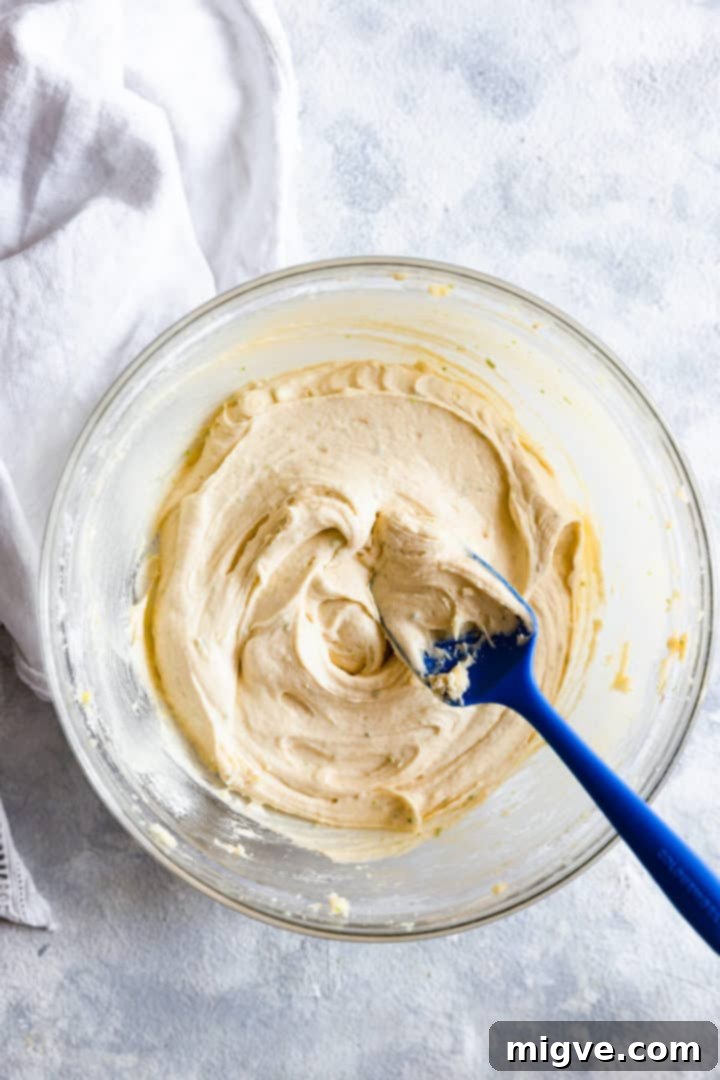 Overhead shot of a bowl filled with smooth, prepared cupcake batter, ready for baking.