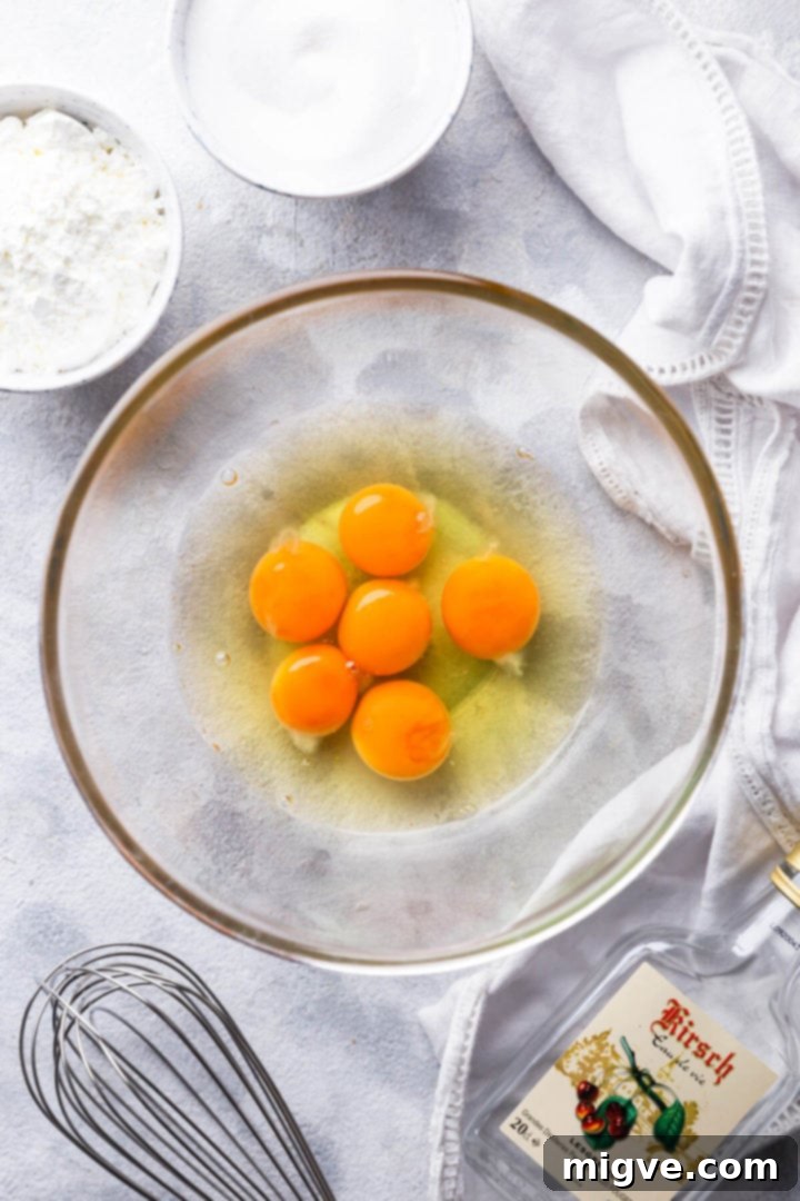 top view of glass bowl with eggs and egg yolks