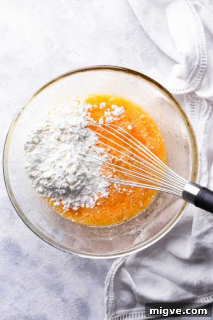 overhead shot of cornflour in a bowl with egg mixture