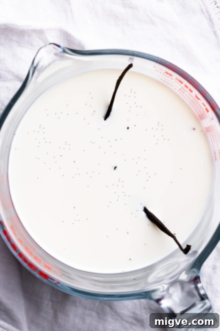 top view close up of a jug with milk and vanilla pod inside