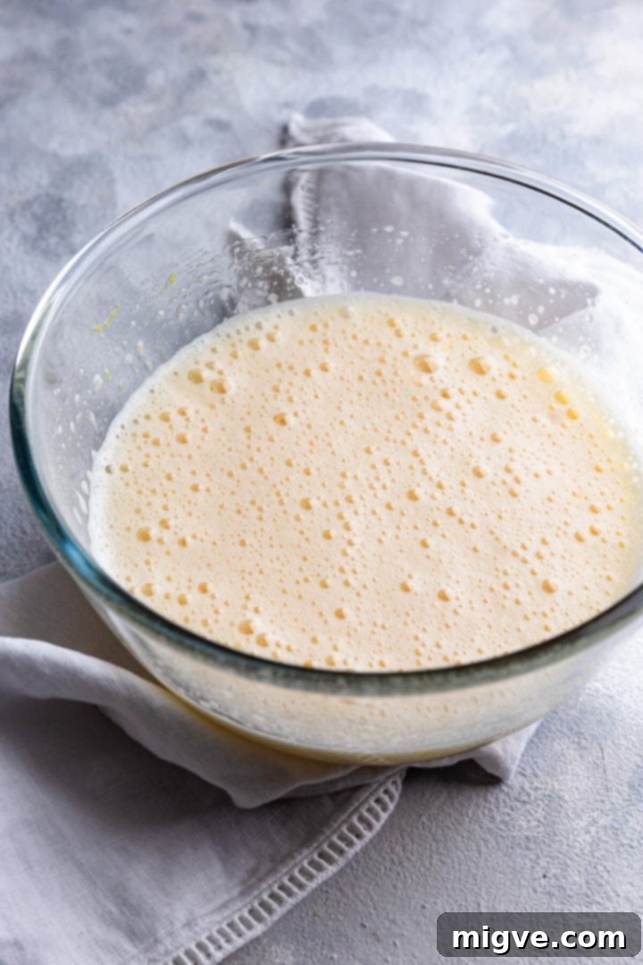 side close up f a bowl with whipped egg and sugar mixture