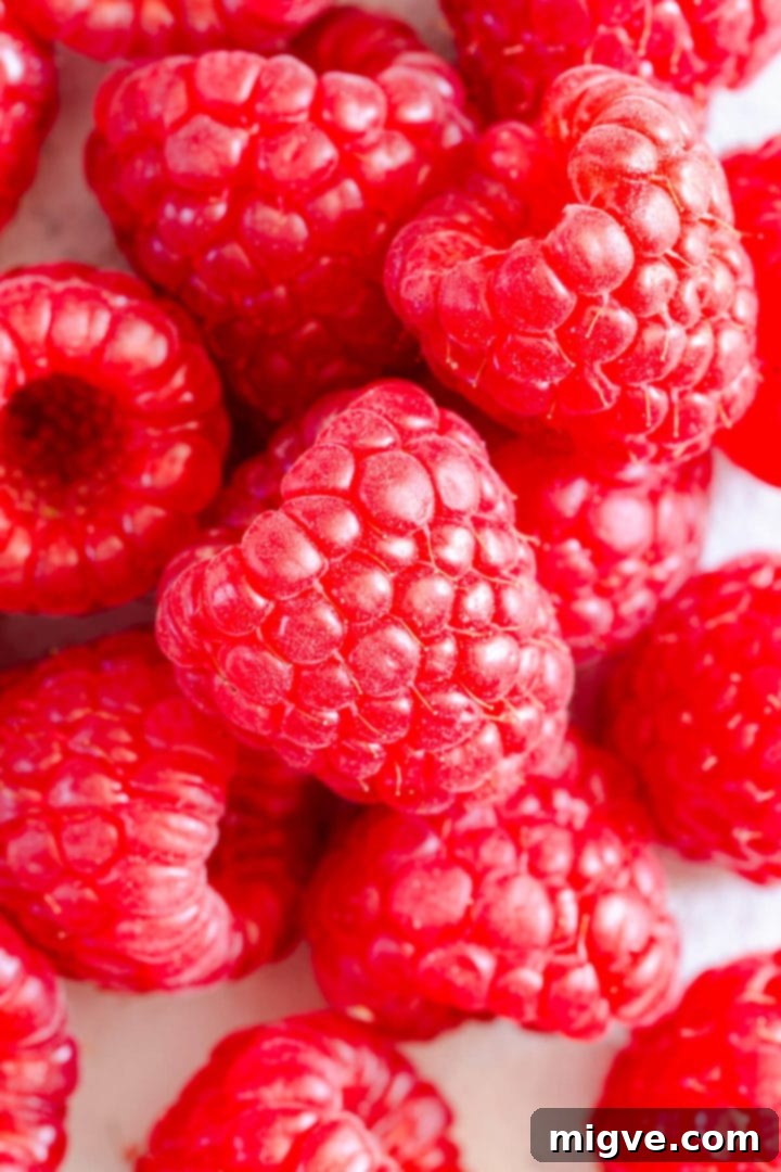 Lemon Raspberry Cheesecake Delights 3 Close-up overhead shot of fresh, vibrant raspberries, ready for baking