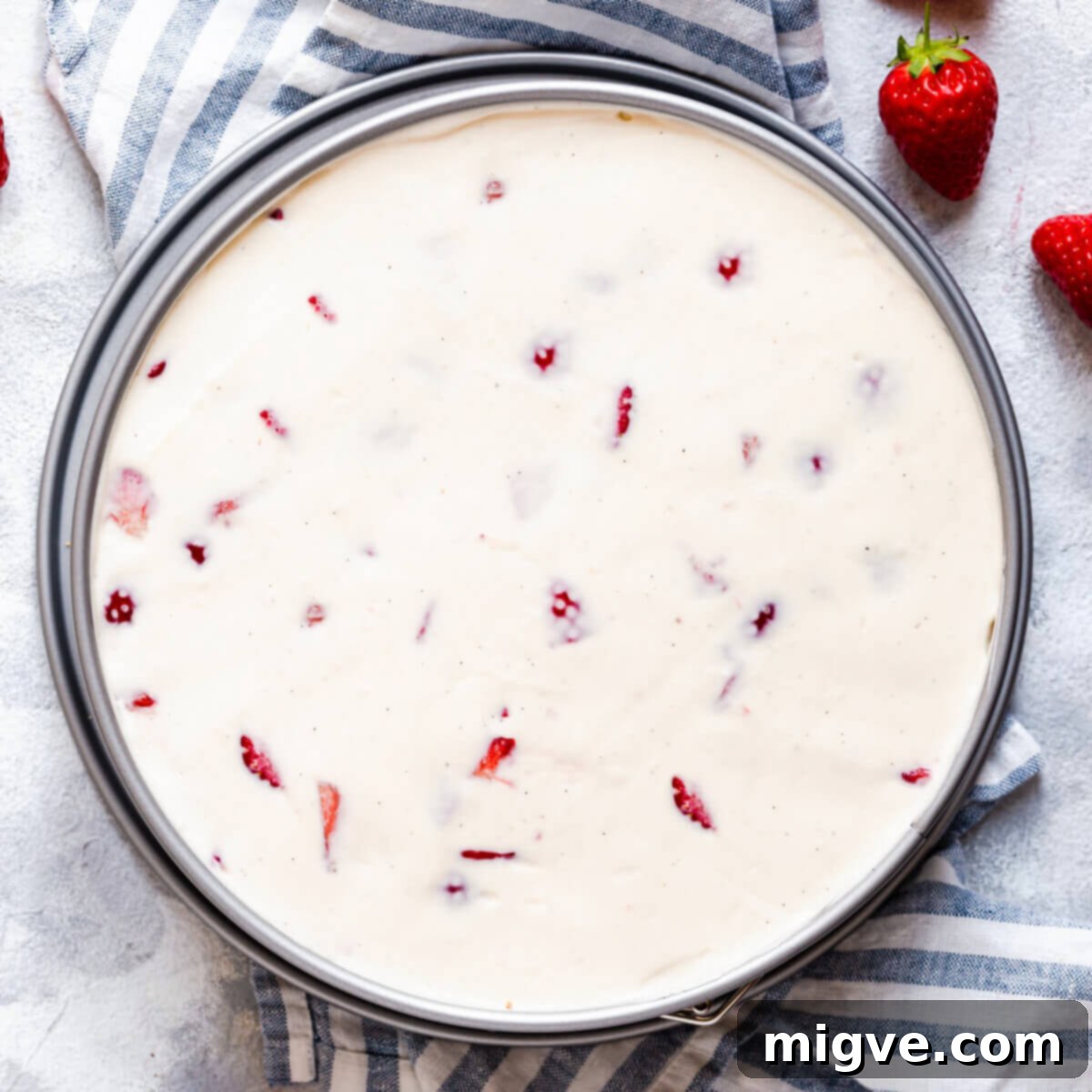 Velvet Strawberry White Chocolate Cheesecake 12 top view of cheesecake in a round cake tin