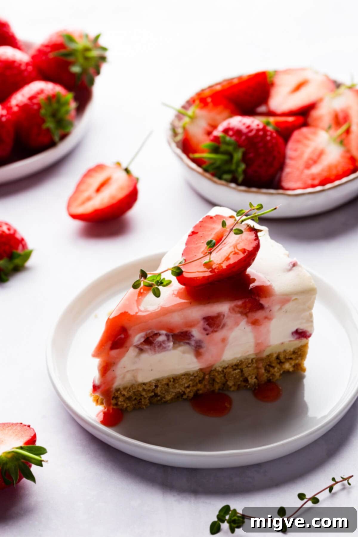 Velvet Strawberry White Chocolate Cheesecake 15 45 degree view of a single slice of strawberry white chocolate cheesecake on a small plate