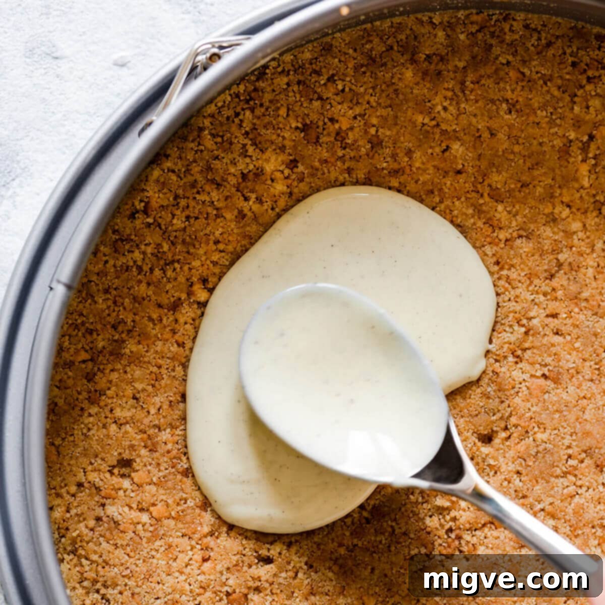 Velvet Strawberry White Chocolate Cheesecake 7 top view super close up at cheesecake base being topped with melted white chocolate