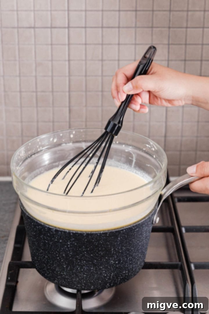 side view of bowl with ice cream mix sat over the saucepan