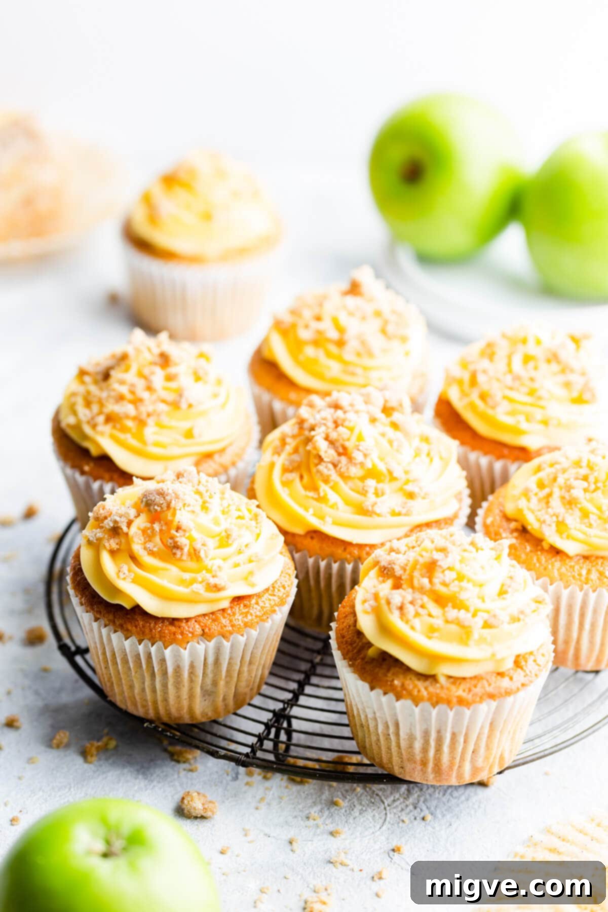 Spiced Apple Crumble Cupcakes 2 45 degree angle view at apple crumble cupcakes on a round wire rack