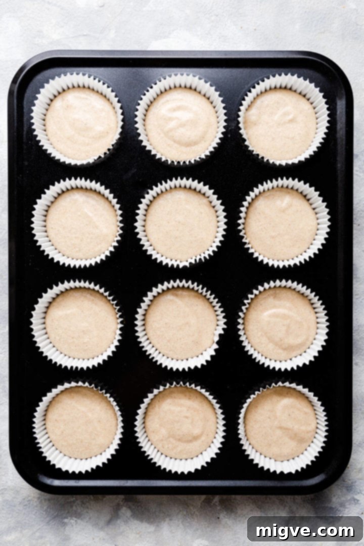 Spiced Apple Crumble Cupcakes 11 top view of the muffin tin filled with 12 cases with cupcake batter