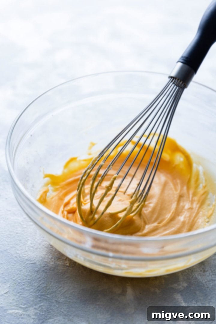 Spiced Apple Crumble Cupcakes 15 side close up at a bowl with custard paste