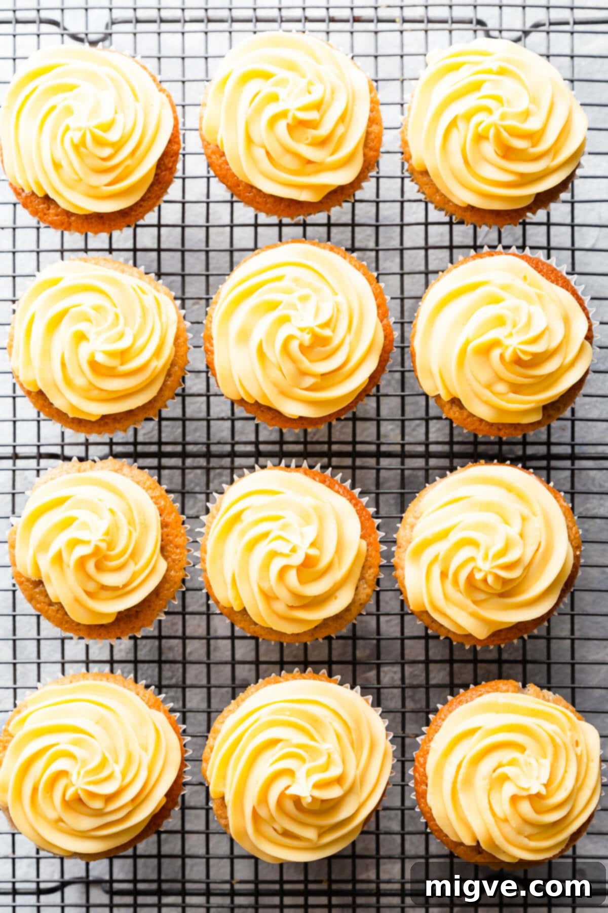 Spiced Apple Crumble Cupcakes 19 top view of 12 frosted cupcakes on a wire rack