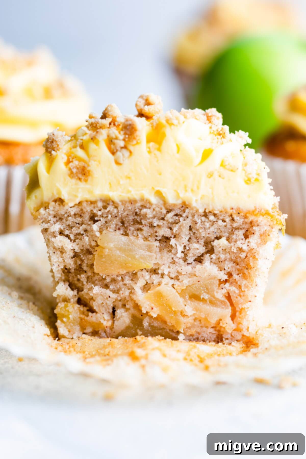Spiced Apple Crumble Cupcakes 22 straight ahead super close up at a cupcake sliced in half showing apple pieces inside