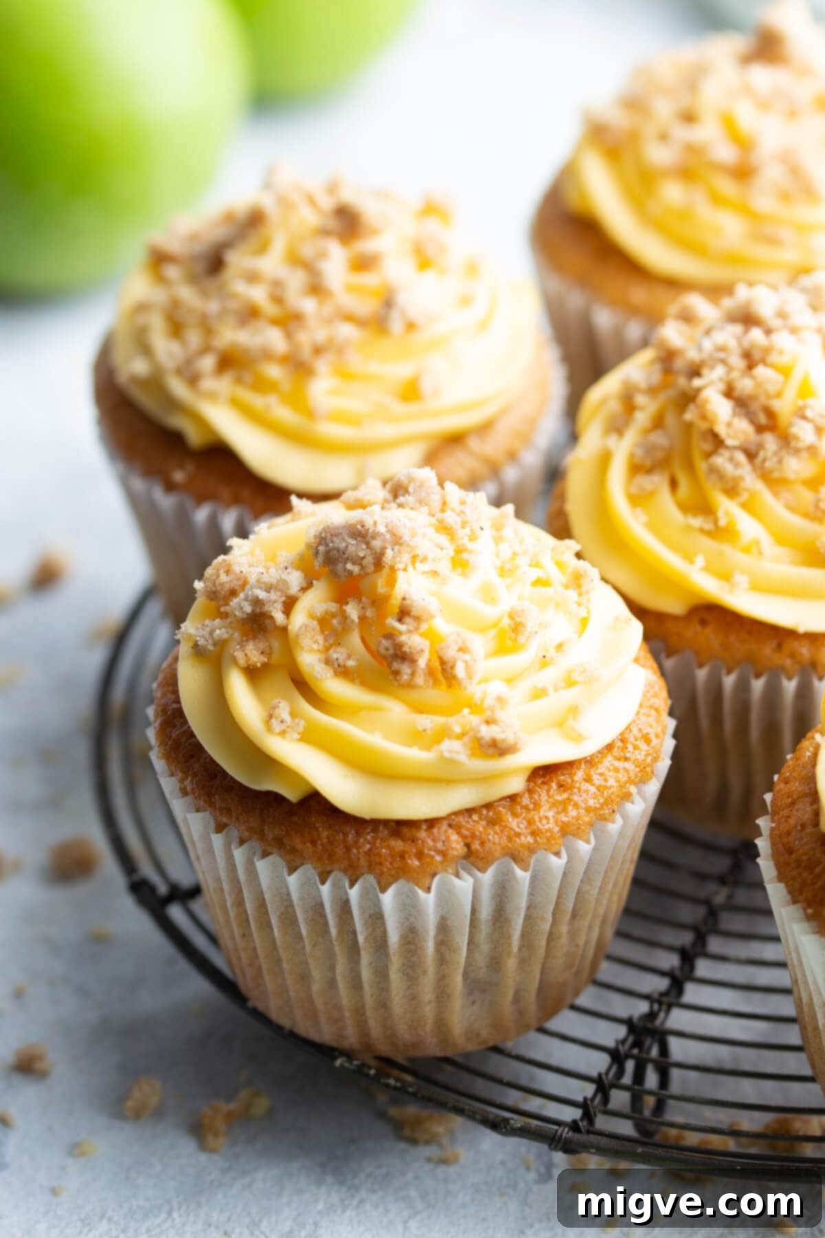 Spiced Apple Crumble Cupcakes 23 45 degree angle close up at cupcake topped with frosting and crumble mix