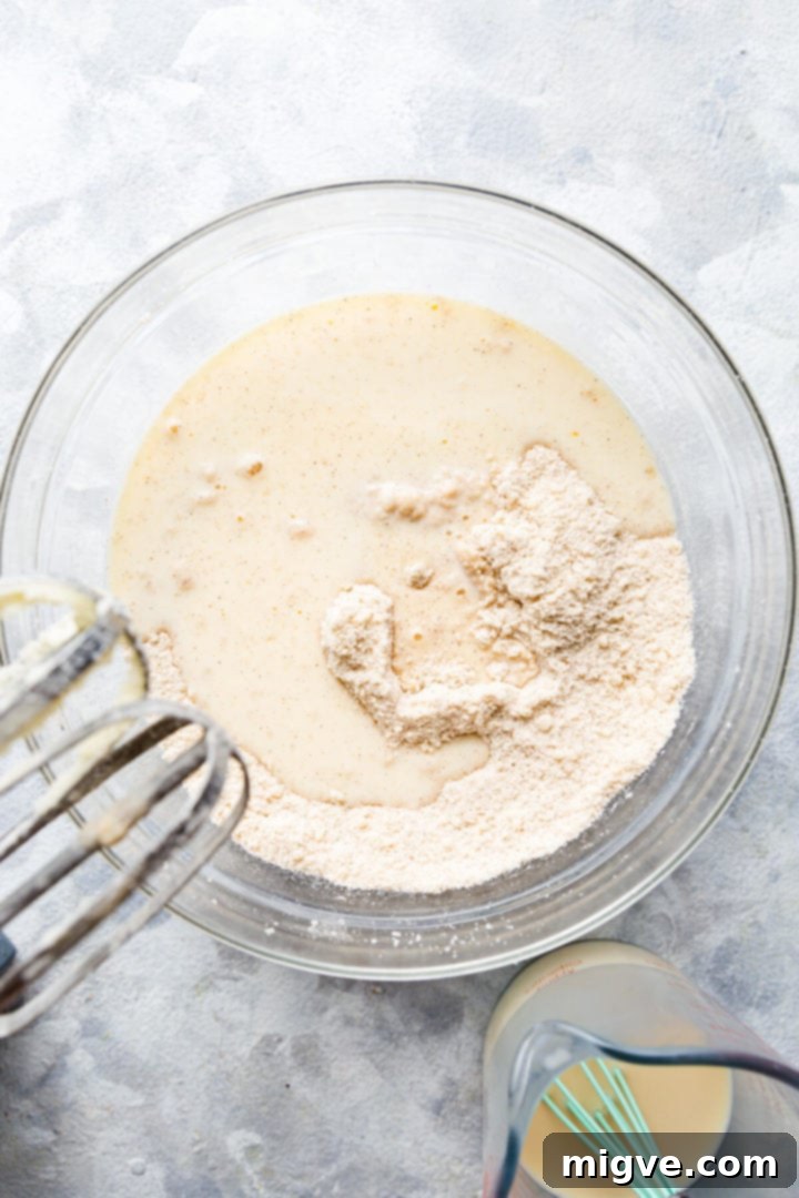 Spiced Apple Crumble Cupcakes 9 overhead shot of wet ingredients being added to the bowl with dry ingredients