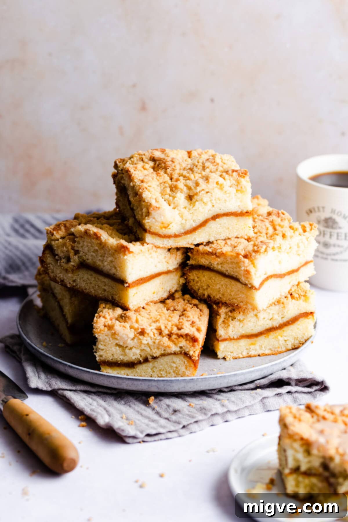 straight ahead photo of slices of pumpkin coffee cake piled up on a blue plate