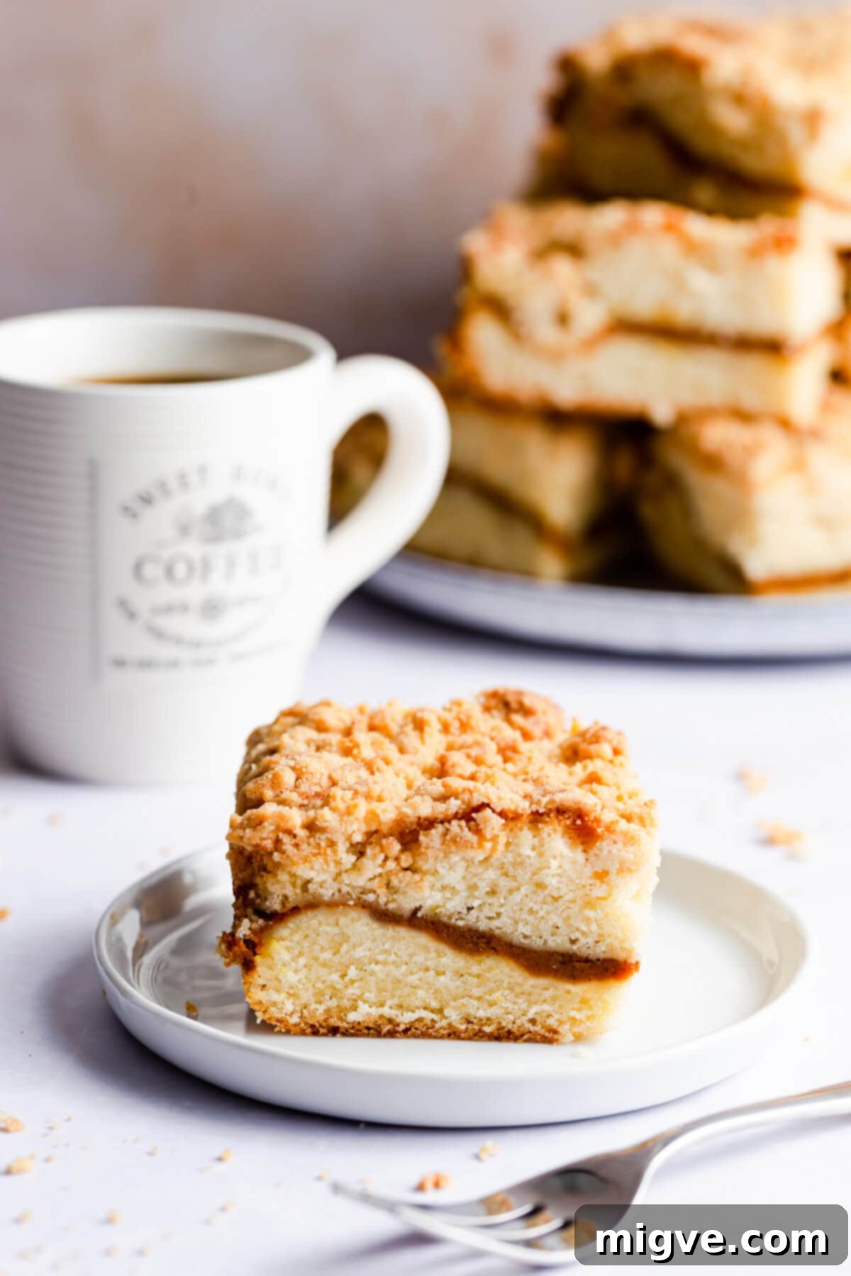 45 degree angle photo of an individual slice of pumpkin coffee cake on a small plate