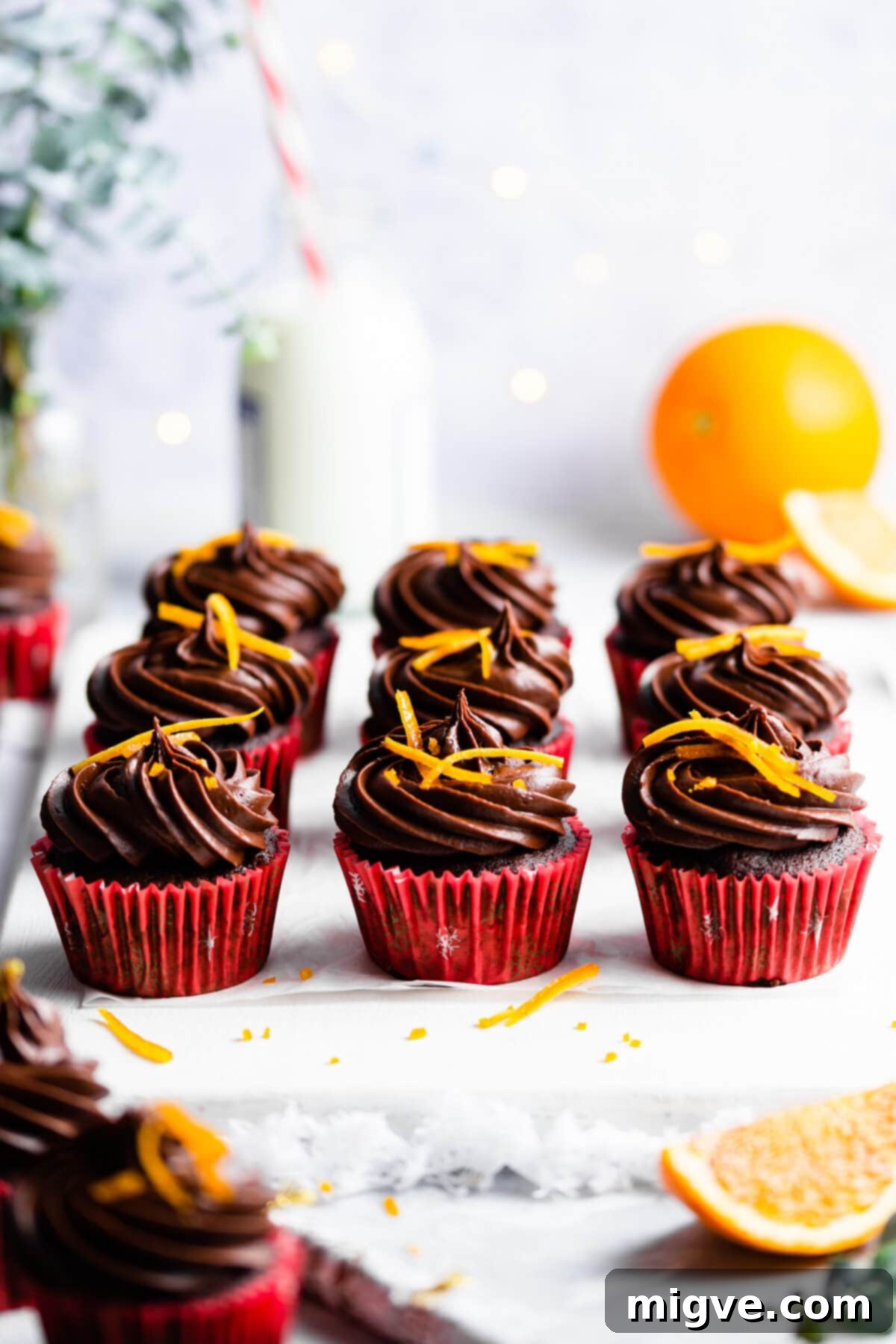 45 degree angle view at chocolate orange cupcakes topped with orange peel