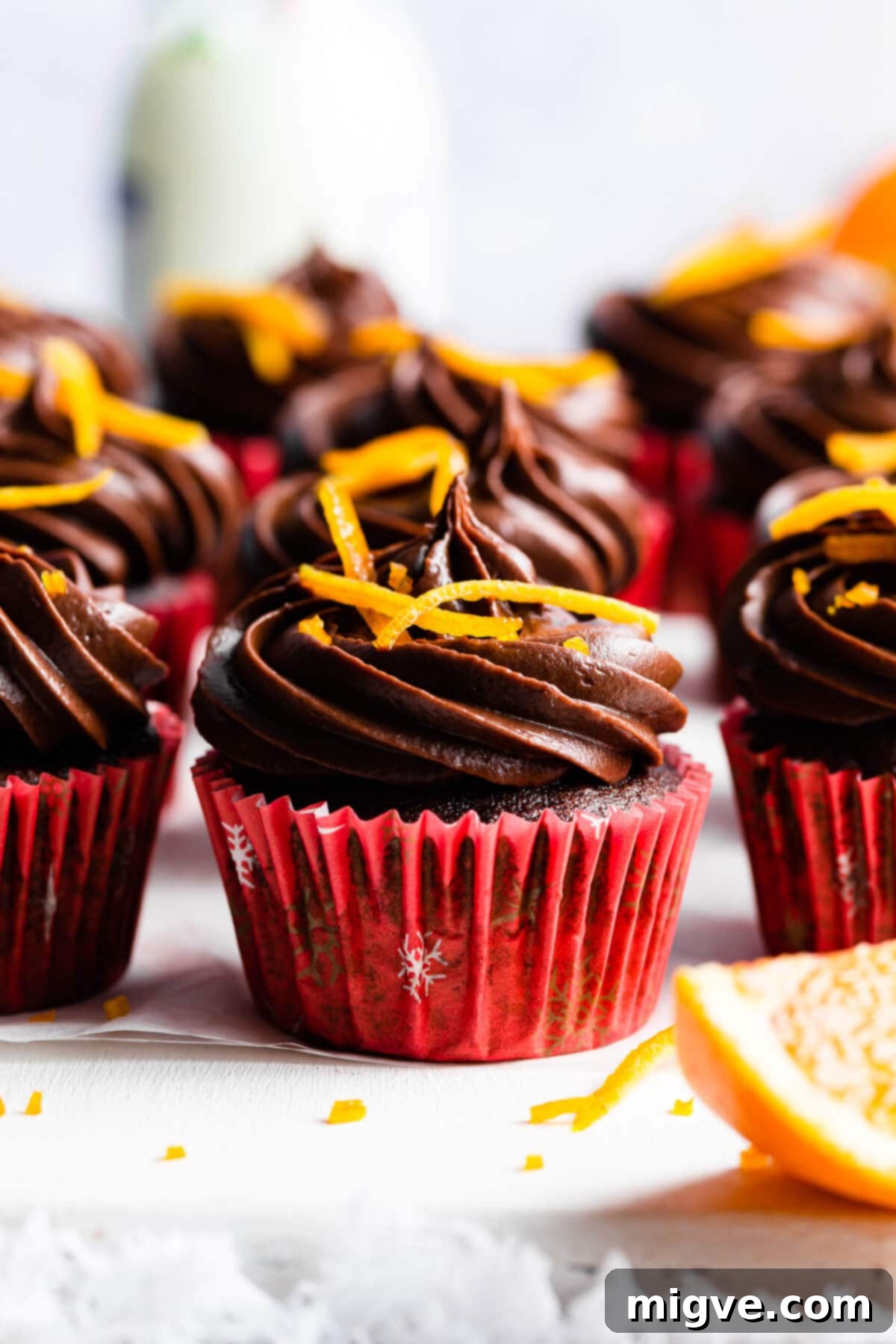 side supaer close up at a single chocolate cupcake with orange peel