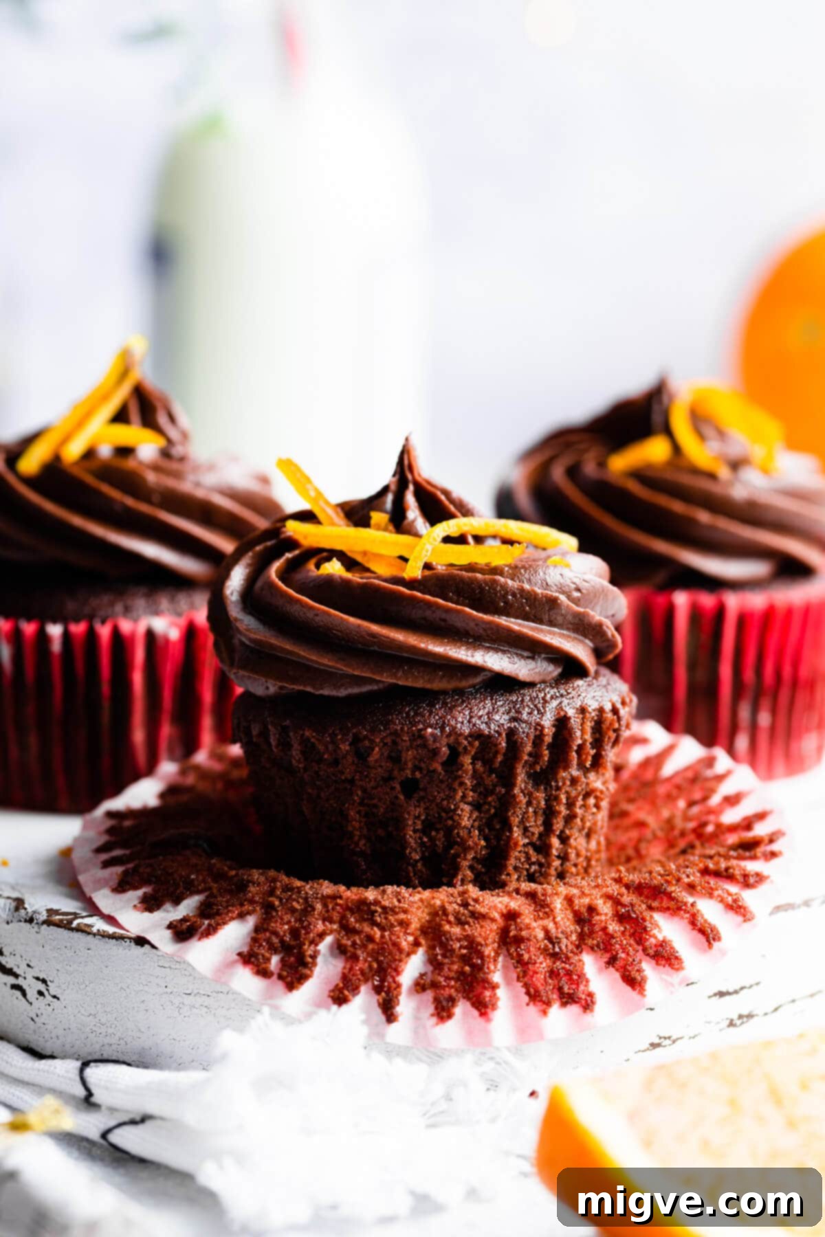 side super close up at a chocolate orange cupcake with paper case peeled off