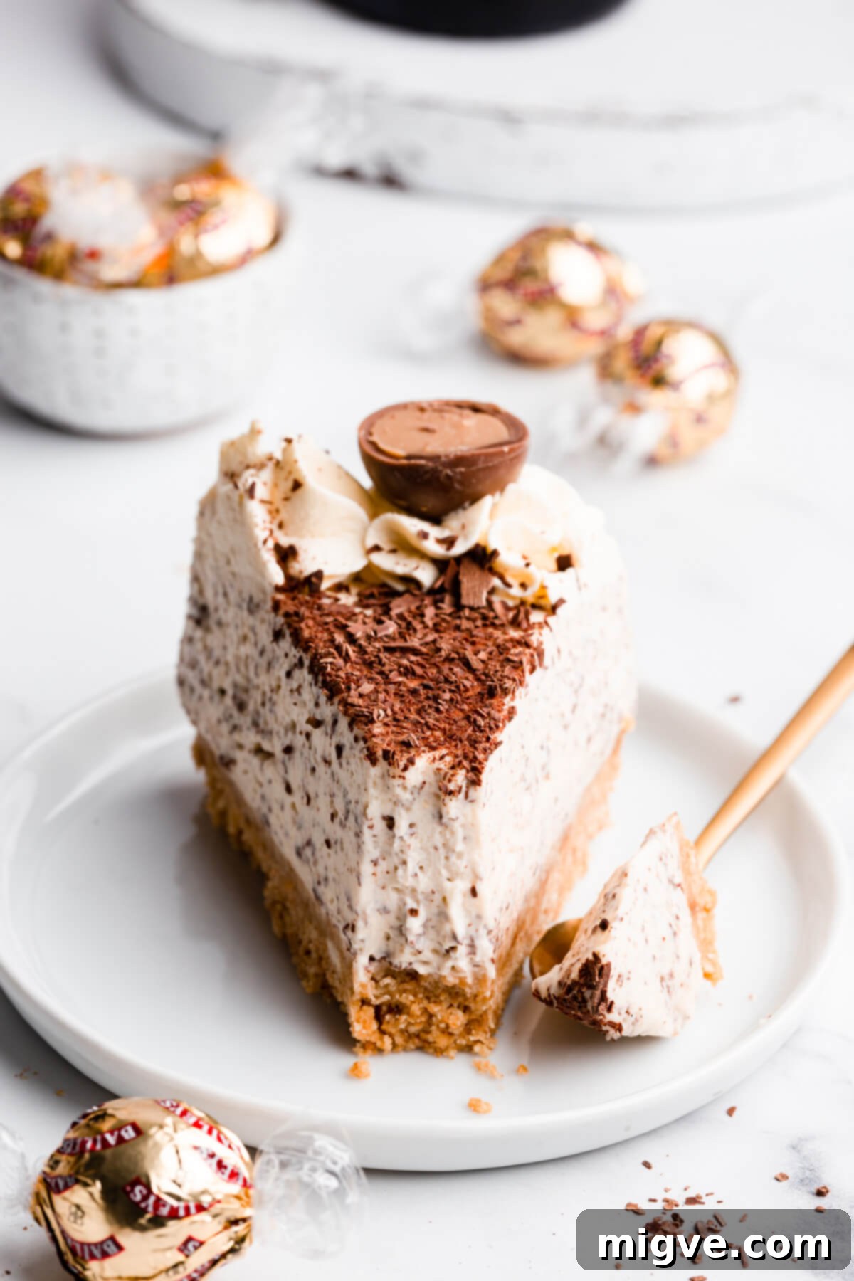 straight ahead super close up at a single slice of cheesecake with a bite missing