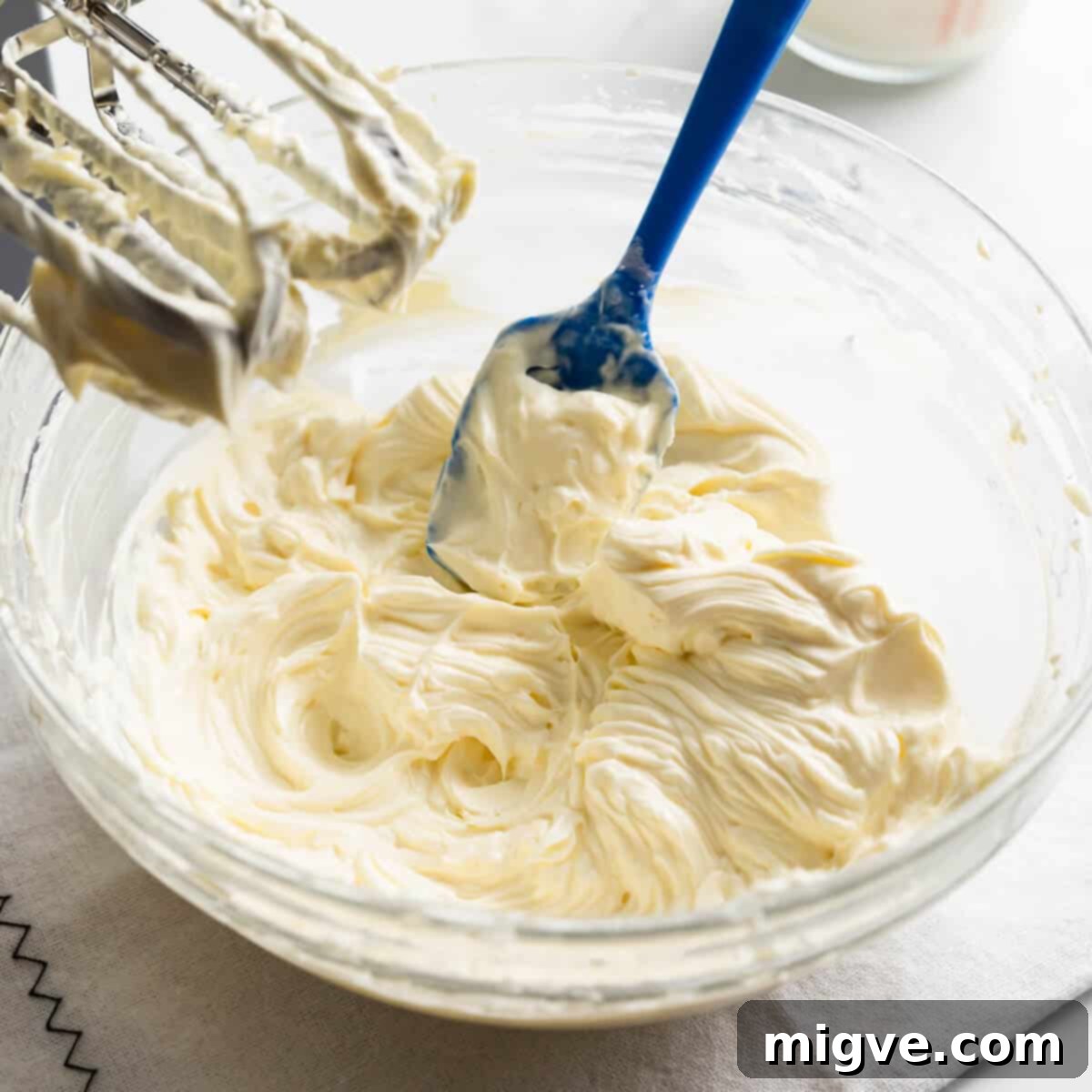 whipped cream cheese inside of the mixing bowl.