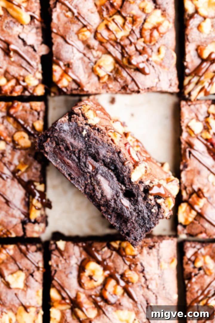 top view super close up at a slice of chocolate brownie showing the fudgy texture and shiny top