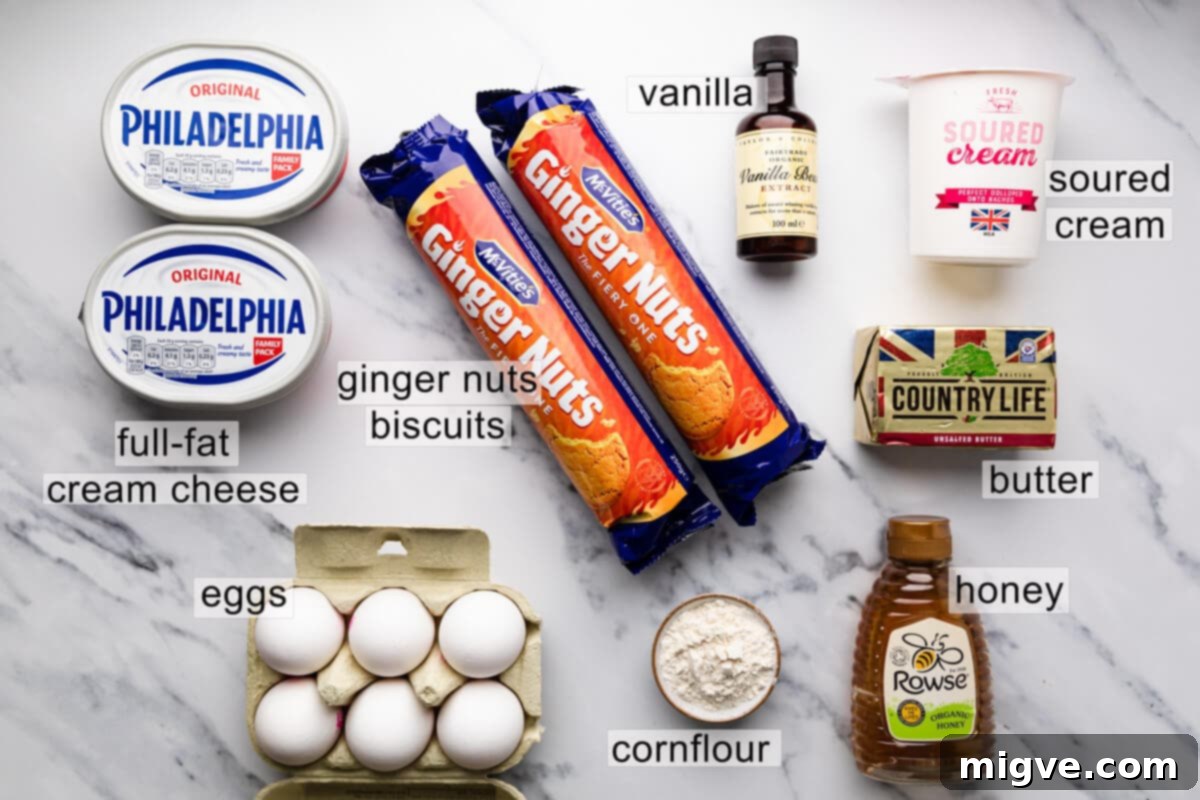 Velvet Honey Cheesecake 3 ingredients for the honey cheesecake with text labels, neatly arranged to show full-fat cream cheese, runny honey, eggs, ginger nut biscuits, butter, cornflour, vanilla, soured cream, heavy cream, sea salt flakes, and lemon juice