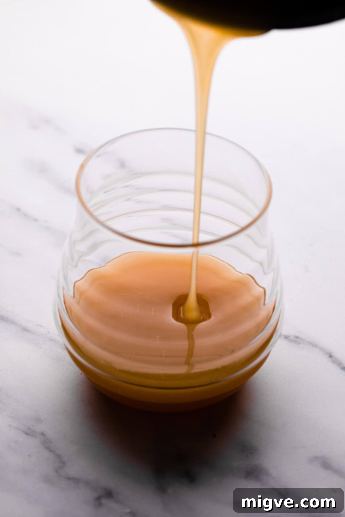 Velvet Honey Cheesecake 5 side view of a pot with salted honey caramelizing, showing its rich golden-brown color