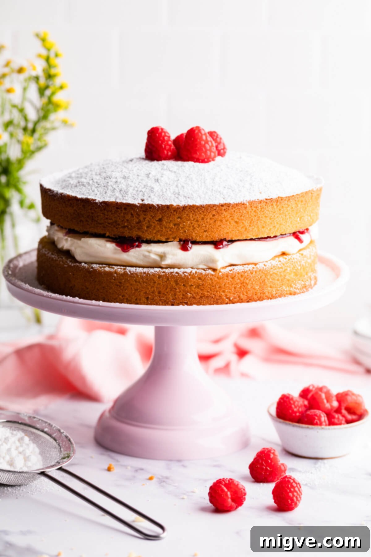 Classic Victoria Sponge 11 Victoria sandwich cake on a pink cake stand