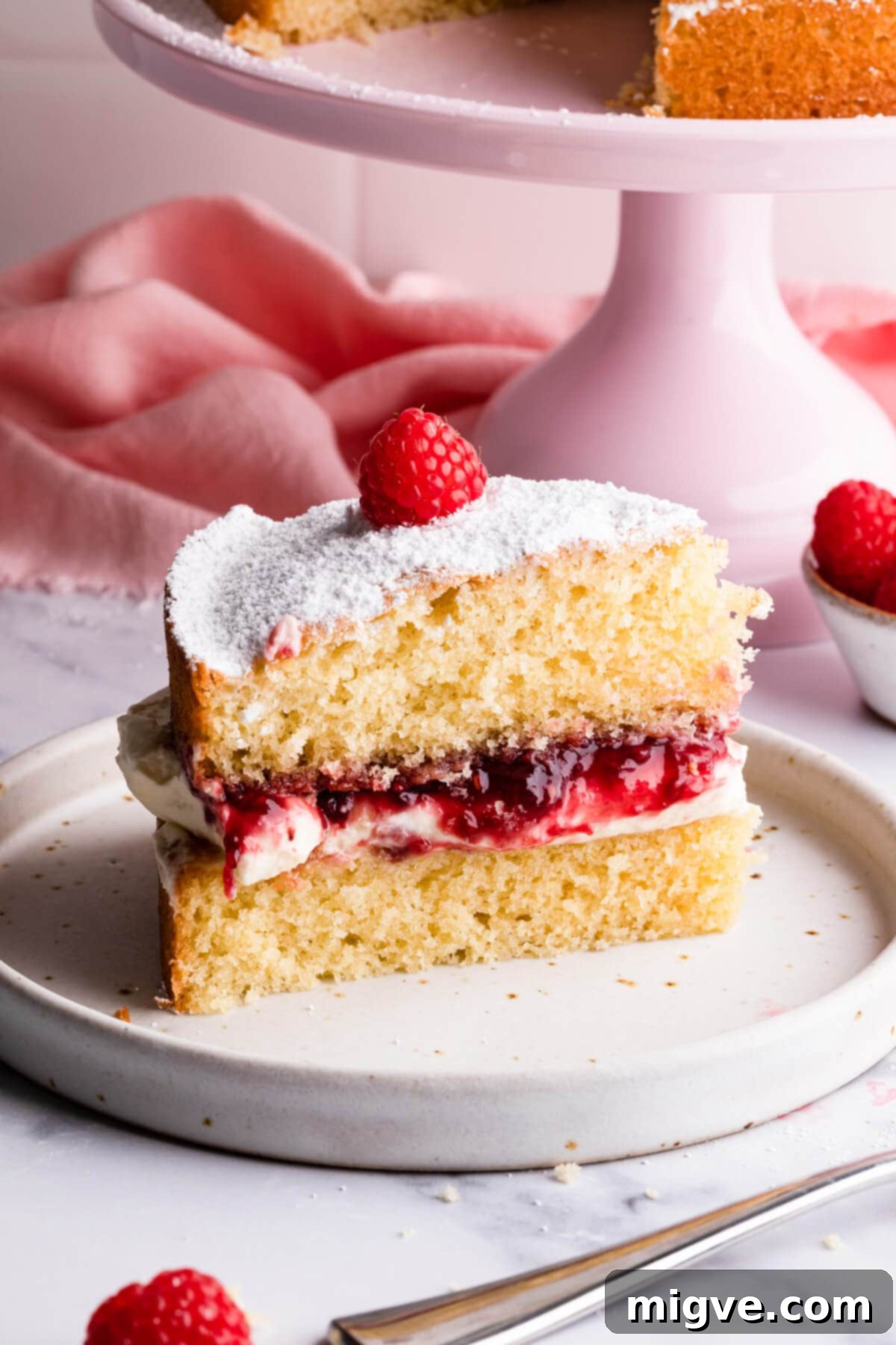 Classic Victoria Sponge 15 super close up of a slice of Victoria sponge cake on a small plate