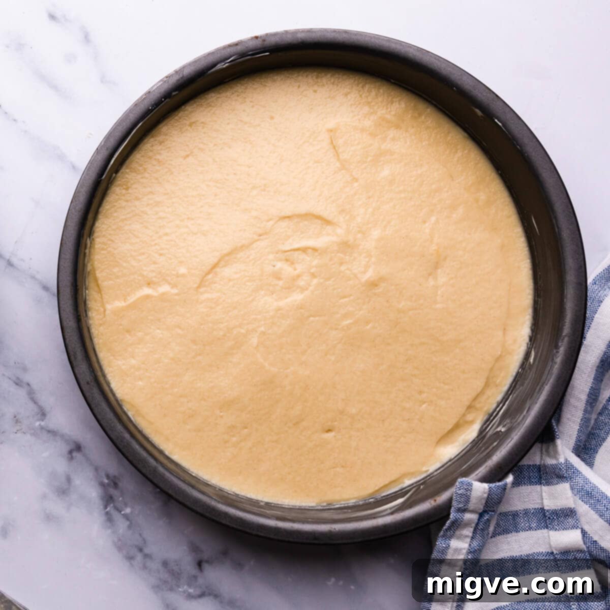 Classic Victoria Sponge 8 top view at a cake tin with cake batter inside
