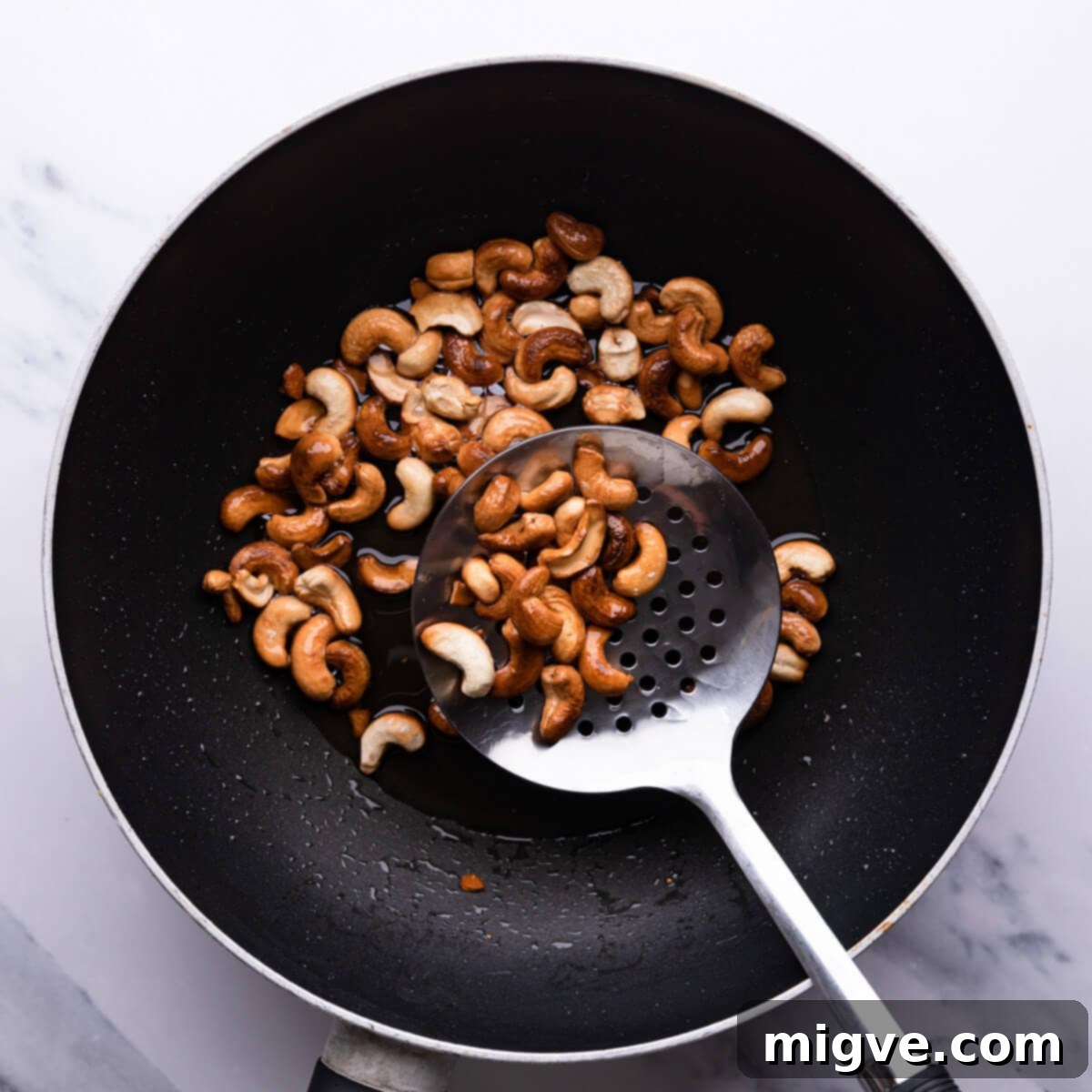 Crunchy Cashew Thai Chicken 5 top down view of a wok with fried cashew nuts