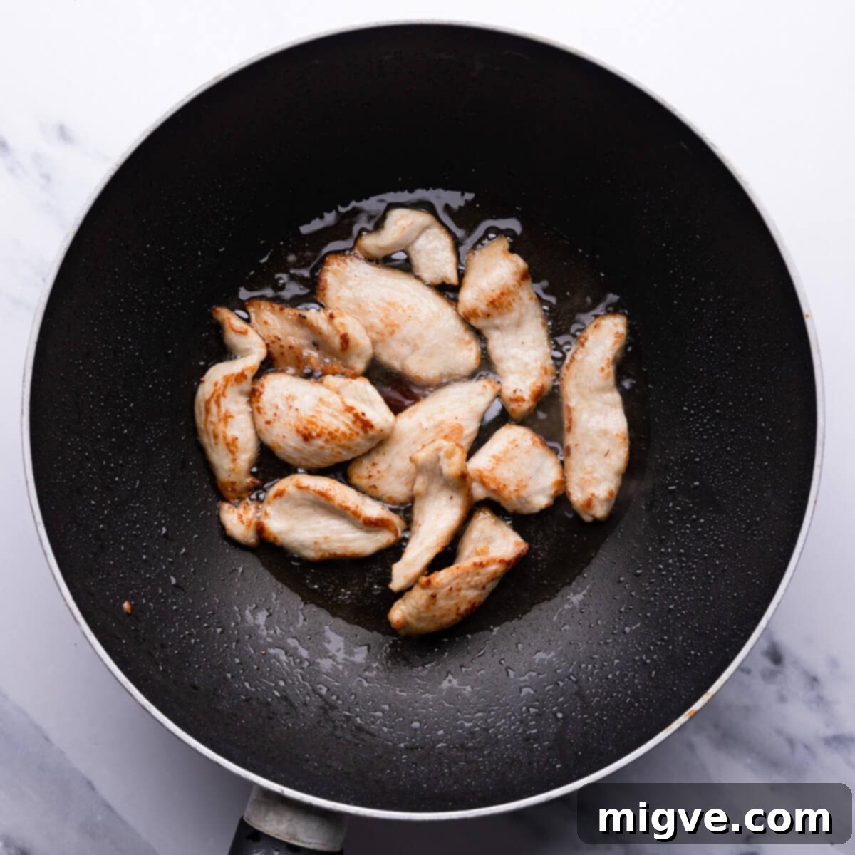 Crunchy Cashew Thai Chicken 6 top down view of chicken being fried in the wok pan