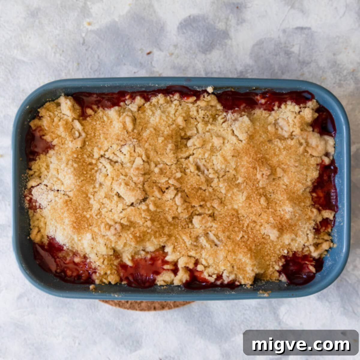 overhead view of a strawberry crumble made with butter rubbed into the flour