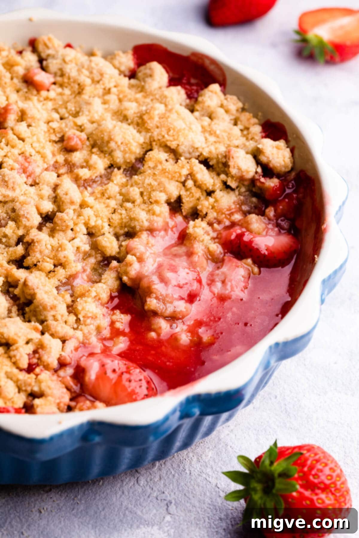 side super close up at a strawberry crumble in a baking dish