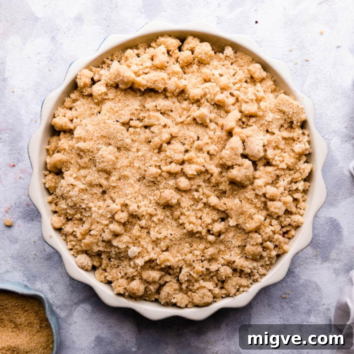 top down photo of a unbaked crumble in a baking dish