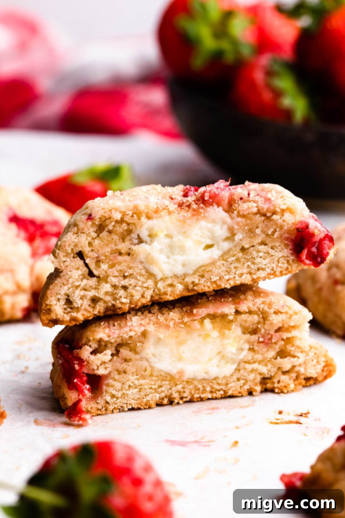 Shortcake Strawberry Cookies 12 A close-up side view of a strawberry shortcake cookie cut in half, revealing the juicy strawberry pieces and the soft, creamy center.