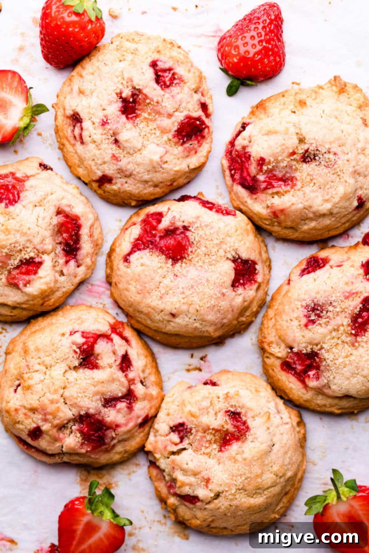 Shortcake Strawberry Cookies 13 Overhead view of several baked strawberry shortcake cookies arranged on a platter, showcasing their vibrant strawberry pieces and golden-brown crust.